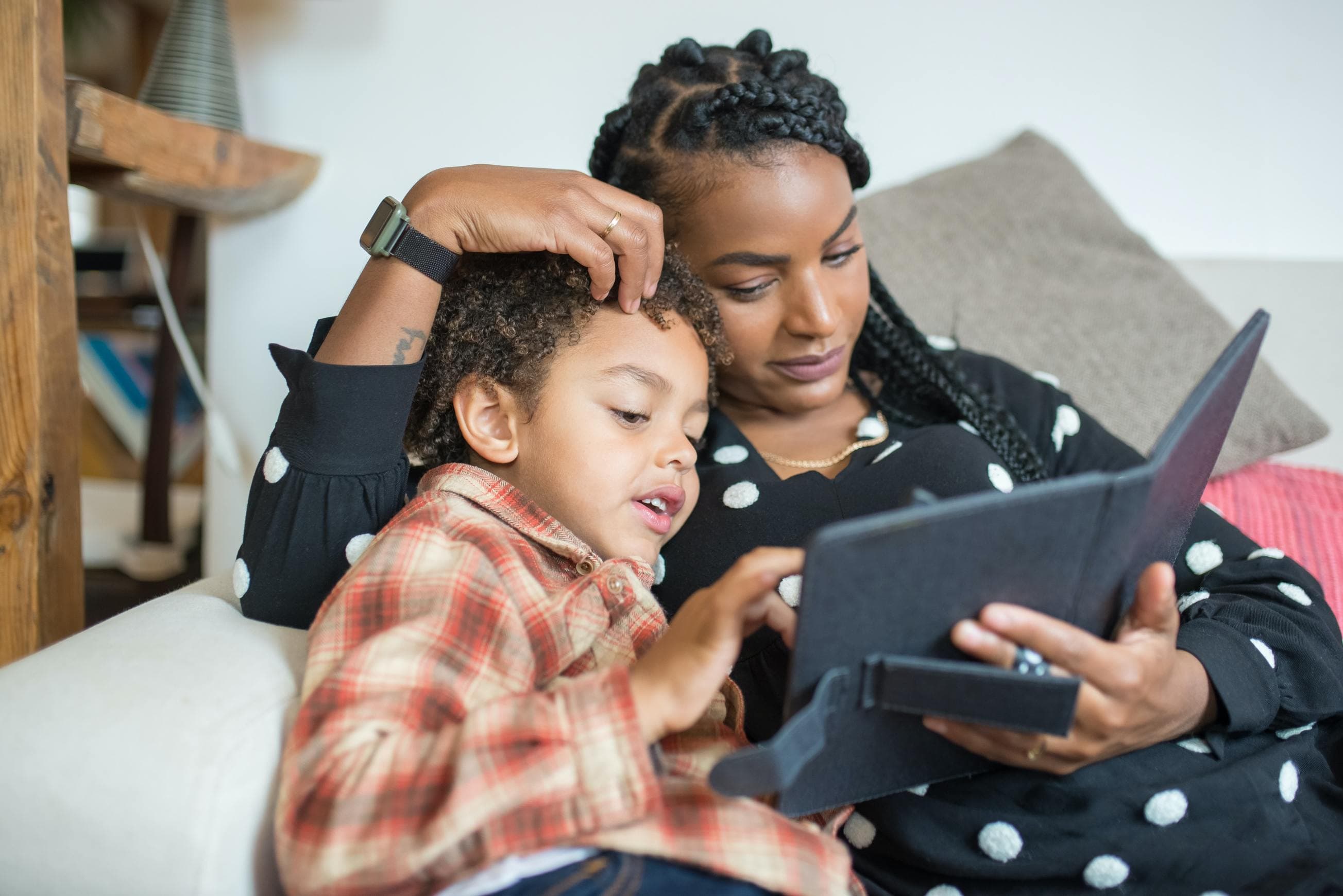 Mother and child sitting on couch