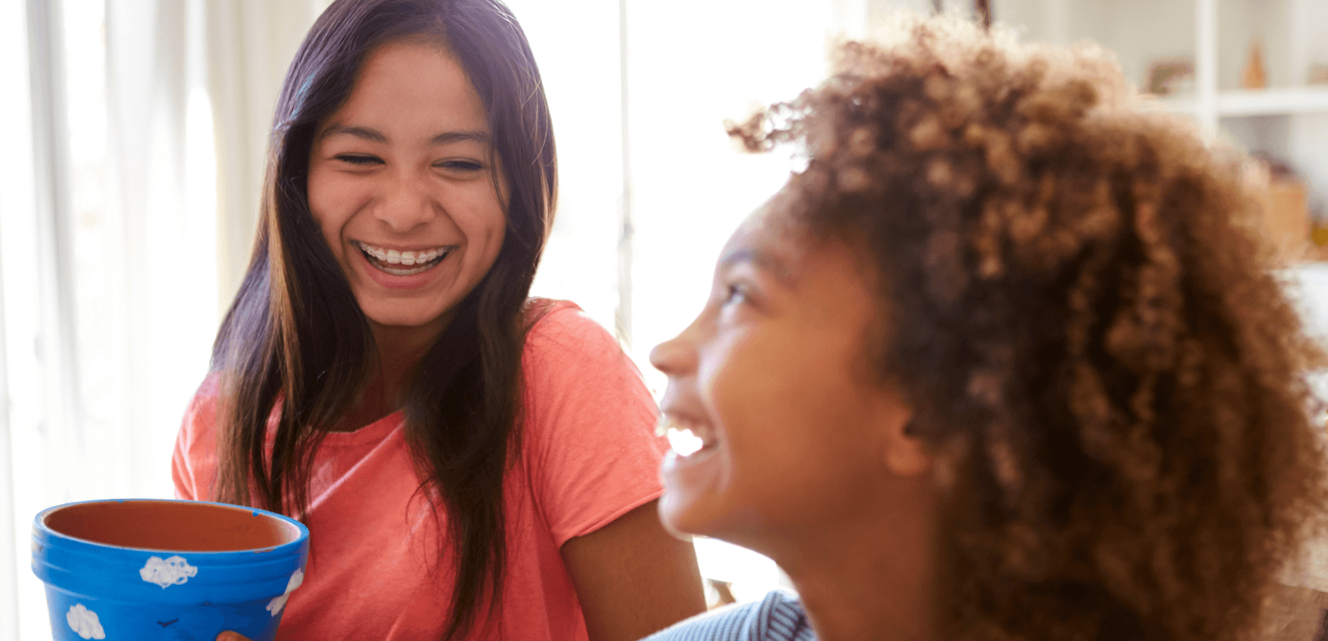 Two preteen girls laughing together